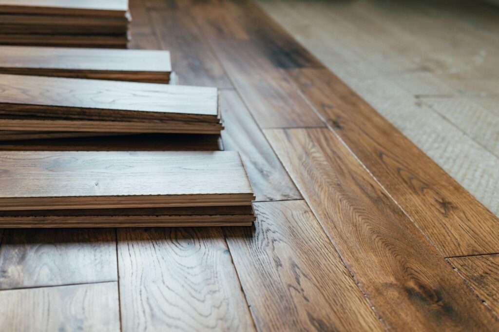 Boards of oak engineered hardwood floors being installed to add an amazing look to a home.